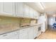 White kitchen with granite countertops and appliances at 2201 S Ocean Blvd. # 1705, Myrtle Beach, SC 29577