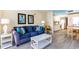 Living area with blue couch, white coffee table, and a view of the kitchen at 2201 S Ocean Blvd. # 1705, Myrtle Beach, SC 29577