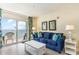 Living room with ocean view, blue couch, and white coffee table at 2201 S Ocean Blvd. # 1705, Myrtle Beach, SC 29577