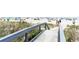Convenient beach access walkway leading to a sandy beach at 7100 N Ocean Blvd. N # 1213, Myrtle Beach, SC 29572