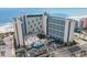 Aerial view of beachfront high-rise building with pool and parking at 7100 N Ocean Blvd. N # 1213, Myrtle Beach, SC 29572
