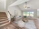 Bright living room with vaulted ceiling, comfy seating, and wood-look floors at 370 Long Meadow Dr., Loris, SC 29569