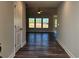 Light-filled hallway with wood-look floors leading to living areas at 370 Long Meadow Dr., Loris, SC 29569