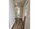 Hallway with wood-look floors and access to bathroom and bedroom at 370 Long Meadow Dr., Loris, SC 29569