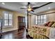 Serene bedroom with hardwood floors, plantation shutters, and a ceiling fan at 478 Riverfront Rd., Conway, SC 29527