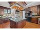 Elegant kitchen with dark wood cabinetry, granite island, and stainless steel appliances at 101 Greenwich Dr., Georgetown, SC 29440