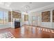 Spacious living room with hardwood floors, fireplace, and large windows at 101 Greenwich Dr., Georgetown, SC 29440