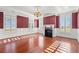 Formal living room with hardwood floors, fireplace, and patterned wallpaper at 101 Greenwich Dr., Georgetown, SC 29440