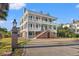 Three-story home with white siding, brick accents, and grand staircase at 101 Greenwich Dr., Georgetown, SC 29440