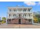 Three-story home with white siding, brick accents, and grand staircase at 101 Greenwich Dr., Georgetown, SC 29440