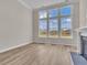 Bright living room with large windows, hardwood floors and a fireplace at 1224 Colusa Ct., Little River, SC 29566