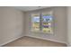 Well-lit bedroom with large window and neutral carpeting at 1224 Colusa Ct., Little River, SC 29566