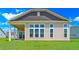 Rear view of home showcasing a covered patio and large windows at 1224 Colusa Ct., Little River, SC 29566