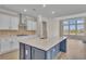 Modern kitchen with white shaker cabinets, stainless steel appliances, and a large island at 1224 Colusa Ct., Little River, SC 29566