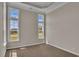 Bright bedroom with neutral walls, carpet flooring, and large windows at 1224 Colusa Ct., Little River, SC 29566
