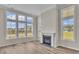 Bright living room with large windows, hardwood floors and a fireplace at 1224 Colusa Ct., Little River, SC 29566