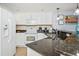 Well-equipped kitchen with granite countertops and white cabinets at 603 S Ocean Blvd. # 1115, North Myrtle Beach, SC 29582