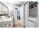 Functional bathroom with a washer and dryer, vanity, and linen closet at 7700 Porcher Dr. # 3207, Myrtle Beach, SC 29572
