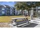 Outdoor picnic table and grills in a grassy area at 7700 Porcher Dr. # 3207, Myrtle Beach, SC 29572