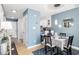 Bright dining area with table and chairs, light blue walls, and a stylish light fixture at 7700 Porcher Dr. # 3207, Myrtle Beach, SC 29572