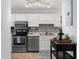 Clean and bright kitchen with white cabinets and stainless steel appliances at 7700 Porcher Dr. # 3207, Myrtle Beach, SC 29572