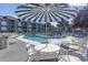 Community pool with lounge chairs and patio tables at 7700 Porcher Dr. # 3207, Myrtle Beach, SC 29572