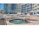 Resort-style pool and hot tub area with lounge chairs and patio tables at 300 N Ocean Blvd. # 1520, North Myrtle Beach, SC 29582
