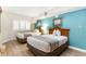 Bedroom with two double beds, teal walls, and light wood flooring at 4800 S Ocean Blvd. # 615, North Myrtle Beach, SC 29582