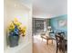 View from hallway into living area with flowers and sunny view from balcony at 4800 S Ocean Blvd. # 615, North Myrtle Beach, SC 29582