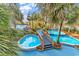 Two connecting pools with a small bridge and palm trees at 4800 S Ocean Blvd. # 615, North Myrtle Beach, SC 29582