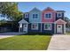 Two-story duplex with gray, teal, and pink exterior and small lawn at 503 30Th Ave. N, Myrtle Beach, SC 29577