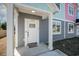 White front door with glass accents, gray siding, and small porch at 503 30Th Ave. N, Myrtle Beach, SC 29577