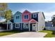 Two-story duplex with gray, teal, and pink exterior, daytime view at 503 30Th Ave. N, Myrtle Beach, SC 29577