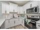 Modern kitchen with white shaker cabinets, stainless steel appliances, and quartz countertops at 503 30Th Ave. N, Myrtle Beach, SC 29577