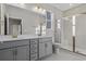 Modern bathroom with double vanity, large shower, and gray cabinets at 3001 Deerberry Place, Longs, SC 29568