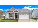 Gray craftsman style home with white garage door and landscaping at 3001 Deerberry Place, Longs, SC 29568