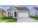 Gray craftsman style home with white garage door and landscaping at 3001 Deerberry Place, Longs, SC 29568