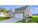 House exterior with white garage door and landscaping at 3001 Deerberry Place, Longs, SC 29568