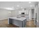 Modern kitchen with gray island, white cabinets, and stainless steel appliances at 3001 Deerberry Place, Longs, SC 29568