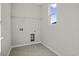 Laundry room with tile floor, window, and built in shelving at 3001 Deerberry Place, Longs, SC 29568