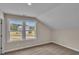 Bedroom with two windows showcasing a neighborhood view and neutral decor at 1216 Colusa Ct., Little River, SC 29566