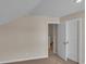 Upstairs bedroom with neutral walls and carpet, featuring an open door to a hallway at 1216 Colusa Ct., Little River, SC 29566