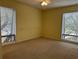 Bright bedroom with carpeted floors and two windows at 178 Salt Marsh Circle # 30F, Pawleys Island, SC 29585