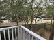 View from balcony showcasing a tree-filled backyard and fence at 178 Salt Marsh Circle # 30F, Pawleys Island, SC 29585