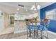 Kitchen with breakfast bar, light cabinets, and tiled backsplash at 2711 S Ocean Blvd. S # 1421, North Myrtle Beach, SC 29582