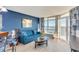Living room with ocean view, blue sofa, and light wood floors at 2711 S Ocean Blvd. S # 1421, North Myrtle Beach, SC 29582