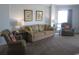 Comfortable living room with sofa, armchairs, and ample natural light at 302 71St Ave. N # 503, Myrtle Beach, SC 29572