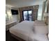 King-size bed in spacious bedroom with balcony access at 7100 N Ocean Blvd. # 219, Myrtle Beach, SC 29572
