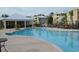 Community pool with a clubhouse, lounge chairs, and a surrounding patio at 35 Delray Dr. # 1-D, Murrells Inlet, SC 29576