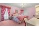 Spacious bedroom with pink carpet and floral bedding at 5 Jessamine St., Andrews, SC 29510